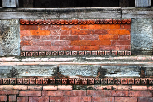 Red bricks, intricate wooden carvings of the Mahasthan Ghar