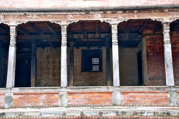Red bricks, intricate wooden carvings of the Mahasthan Ghar