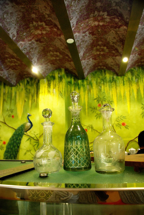 An intricately hand painted wall complimenting the hand crafted bottles