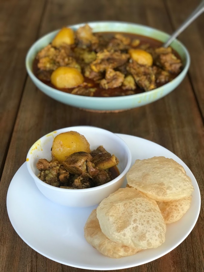 Phulko luchi with Kasha Mangsho, slow cooked tender goat meat
