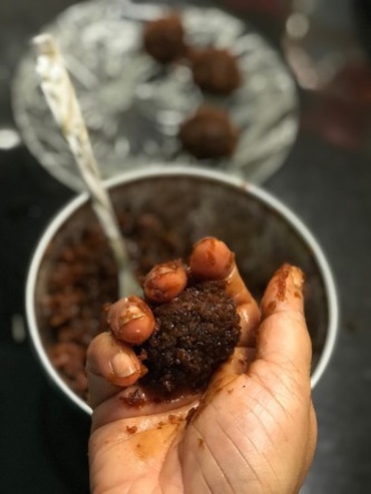 Rolling the coconut-jaggery mixture into truffles